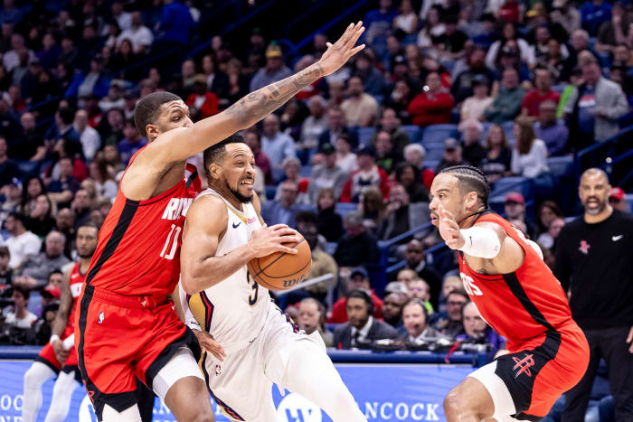 New Orleans Pelicans dribbles against Houston Rockets forward Jabari Smith Jr. (10) and forward Dillon Brooks (9) during the first half at Smoothie King Center.